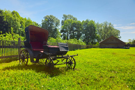 An ancient phaeton carriage on a green rural lawn. Izvara. Leningrad region, Russia.の写真素材