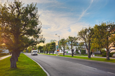 Moscow, Russia - July 12, 2024: Evening green passage on the territory of VDNH. Minibus transfer for tourists. Beautiful summer day with people walking down the street.のeditorial素材