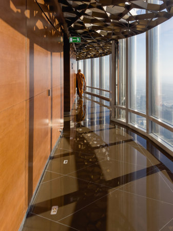 Dubai, UAE - May 27, 2024: Glass corridor in a high-rise building. Architectural view on the metal and wooden observation platform of the high building. Burj Khalifa. Dubaiのeditorial素材