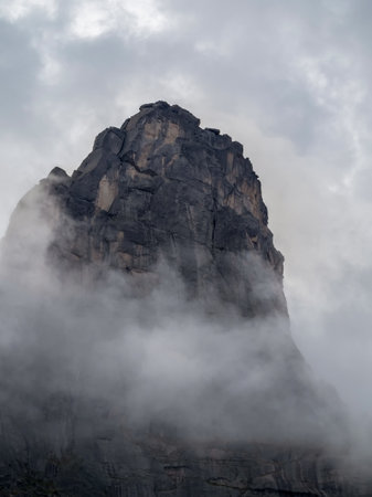 Dramatic deep gorge with sharp sheer crags silhouettes against dark clouds. Amazing atmospheric...