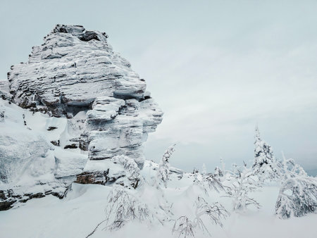 Beautiful winter landscape with snow-covered trees and rocks cliff. Deep snow powder. Perm region.の写真素材