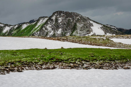 Harsh mountains in summer. Changeable weather in the summer mountains, snowmelts, and recent hail....