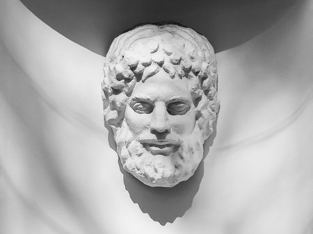 Abstract antique sculpture of a head on a white wall. Antique classic greek philosopher head.