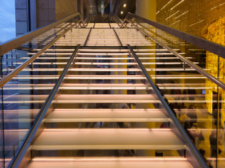 Bottom-up view. Staircase with illuminated steps in a modern interior. Stairs in the interior.