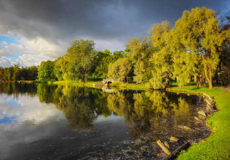 Pond in the Palace Park, Gatchina. Weekend walks in the evening park. The lake is surrounded by...