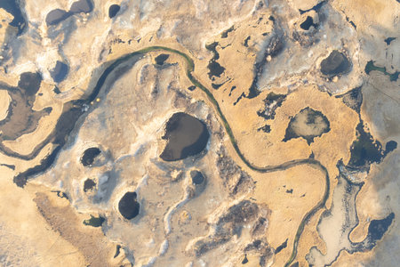 Craters filled with water and a winding river, from above. The texture of the Earthの写真素材