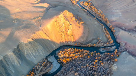 Panoramic views over a mountain valley. Amazing aerial view of beautiful bent river and low clouds creeping on the autumn mountain slopes. Altai. Beautiful natural background.の写真素材