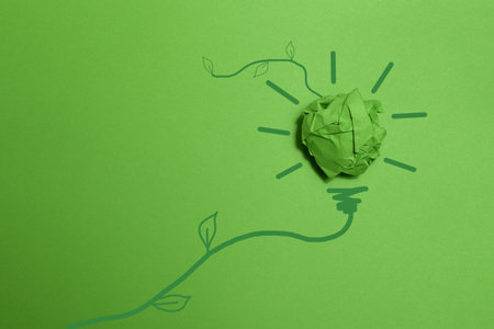 Green crumpled paper light bulb on green background, Corporate Social Responsibility. eco-friendly business and environmental concepts, copy spaceの写真素材