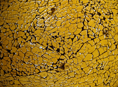 Cracked paint on a yellow wall. Abstract background and texture.の写真素材