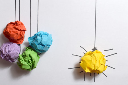 Colored crumpled paper balls and light bulb as creative concept