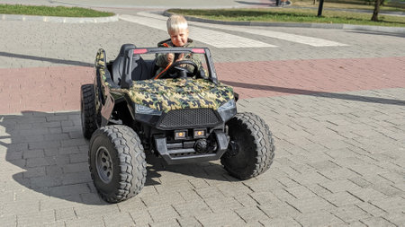 cute boy child rides on electric children's cars