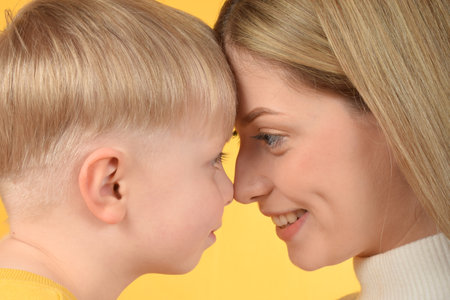 happy mother looking at her baby boyの写真素材