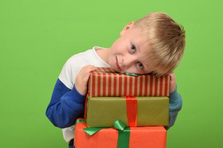 cute boy child holding a gift boxの写真素材