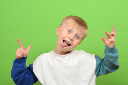 Cute little boy with funny face on color background, closeupの写真素材