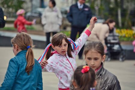 Mirny, Russia - June 12, 2014: Children with ribbons and flags in celebration of the Day of Russia in the city of Mirny, Republic of Sakhaのeditorial素材