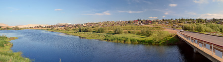 Mirny, Russia - July 7, 2014: Rural area in the town of Mirny, Yakutia. Bridge on the River Irelyakh.のeditorial素材