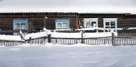 Snowy fence in the countryside. The snow sparkles in the sun. Rural winter scene.  Panorama HDR - high dynamic range.の写真素材