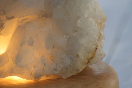 decorative night lamp and stones crystal. beautiful mystical composition with quartz crystal on a larch wood stand.の写真素材