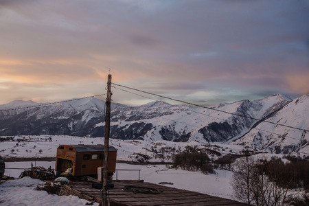 Sunset on the Kaukaz mountains with barn near Gudauri at winter time, Gergiaの写真素材