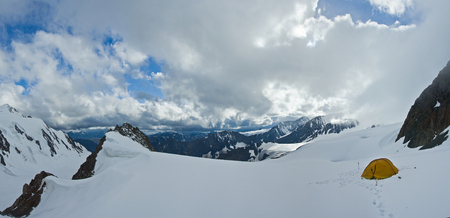 Tent in the snow mountains in Altaj, Russia  at the summerの写真素材