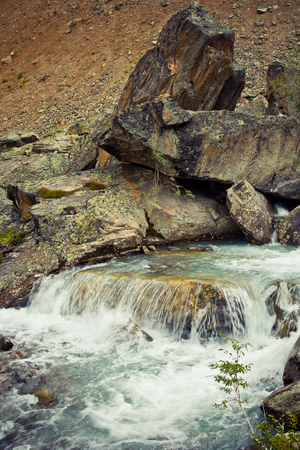 Small waterfall on the stream in the stones in Altaj, Russia  at the summerの写真素材