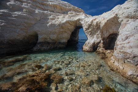 Grotto on the coast  with blue sky  and rocks in the Cyprus near Paphos  at the winterの写真素材