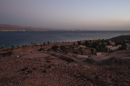 Veiw from mountains to israil and iordan mountains near  of Eilat city in the desert  in the evening sunset  with blue sky and city lightsの写真素材
