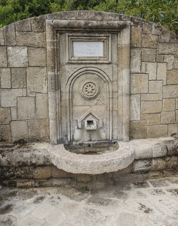 An ancient medieval sandstone drinking fountain. Greece. Rhodesの写真素材