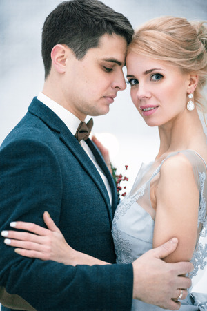 Portrait of bride and groom. They are standing and hugging.  の写真素材