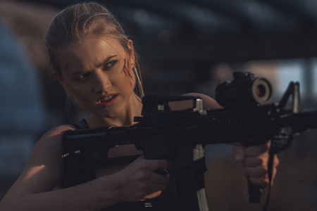 Portrait  of ?osplayer  girl with machine gun in her hands in costume Croft. Cosplay.