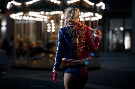 Dnipro, Ukraine - August 17, 2016: Cosplayer girl in costume Harley Quinn on background lights of night city. Cosplay.のeditorial素材