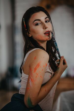 The portrait of artist stained with paint in an art workshop.の写真素材