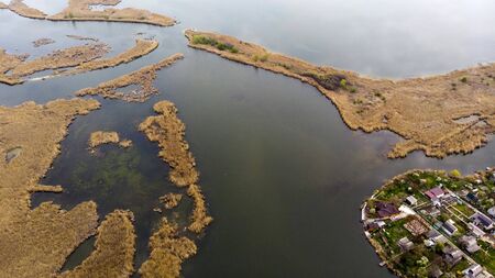 Bird's-eye view to the village, islands and river delta. Drone shooting.