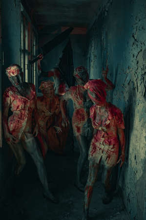 Dnipro, Ukraine - June 27, 2020: Cosplayers in the image of Dark Nurses and executioner Red Pyramid from the horror movie "Silent Hill" stand in dark room.のeditorial素材