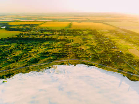 Border of desertification territory and green meadow with river is a result human destructive activity in environment. View from drone.の写真素材
