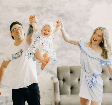 Young parents have a fun and play with their little daughter.の写真素材