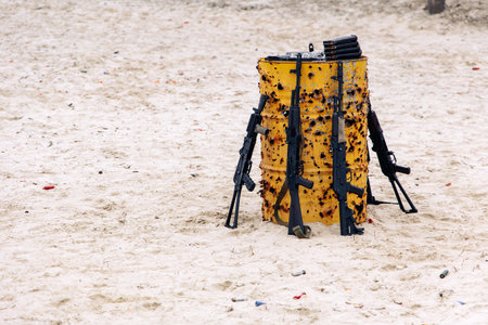 Metal barrel shot through with assault rifles is at training shooting range. It is used as a target.の写真素材