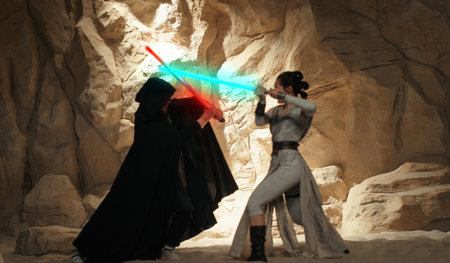 Kyiv, Ukraine - April 14, 2023: Cosplayers portraying lightsaber combat between characters enemies Rey Skywalker and Kylo Ren from the Star Wars universe among sandy canyon.のeditorial素材