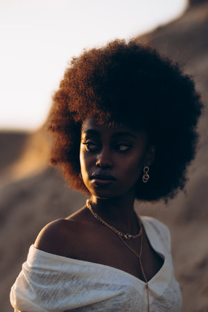 Portrait of young African woman posing outdoor at sunset. Image with backlit.の写真素材