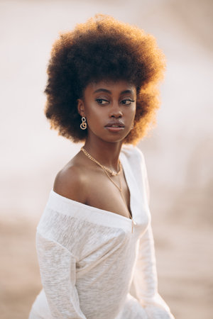 Portrait of young African woman posing outdoor at sunset. Image with backlit.の写真素材