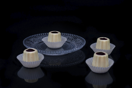 White mousse on a glass vintage plate with mirror reflectionの写真素材