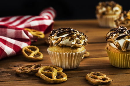 Pretzel cupcakes on wooden tableの写真素材