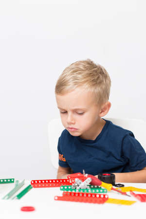 needlework, hand work a little boy collects a children's designer from metalの写真素材