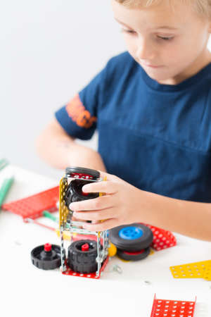 needlework, hand work a little boy collects a children's designer from metalの写真素材