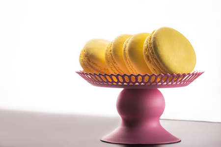 Yellow Macarons on a black background French pasta. Stack of yellow macarons isolated on dark, black background. Macaroonsの写真素材