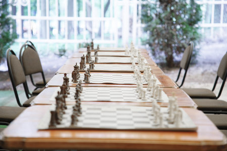 chess tournament, more tables with put up chess figueres. Chess board with figures before starting chess tournamentの写真素材