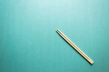 two Chinese chopsticks on the aqua backgroundの写真素材