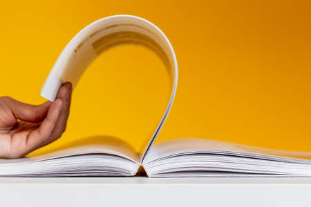 hand leafing through a bookの写真素材