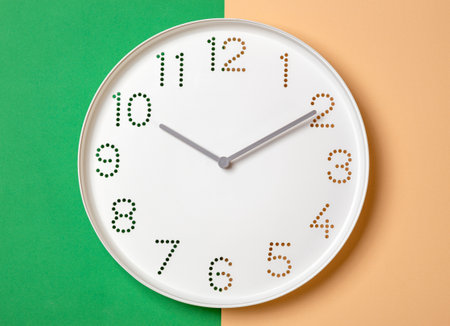 A clock with perforated numbers on a colored