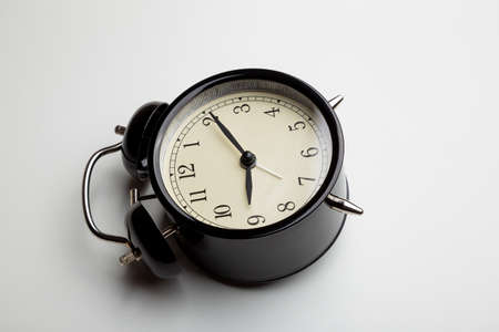 alarm clock lying on back casting a shadow